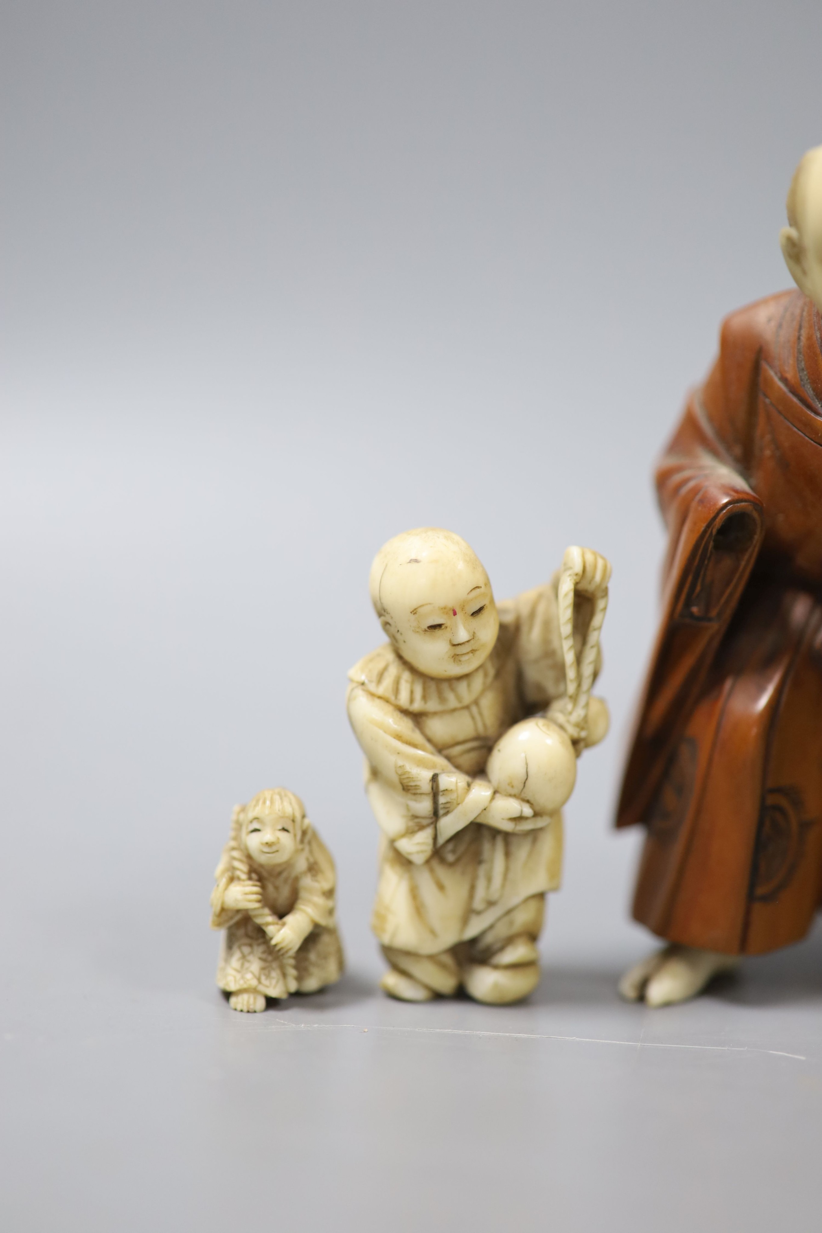 Three Japanese ivory netsuke, a similar okimono and a boxwood and ivory okimono, 9cm (losses)